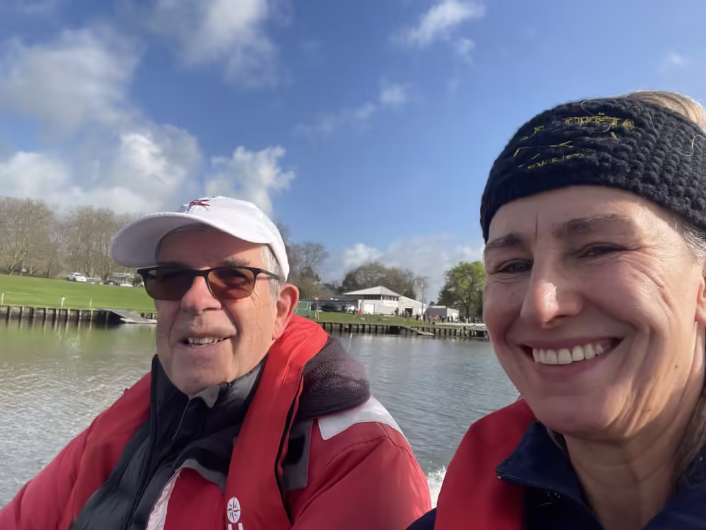 Man and woman in rowing coaching launch.